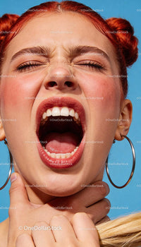 Young woman expressing distress and discomfort outdoors