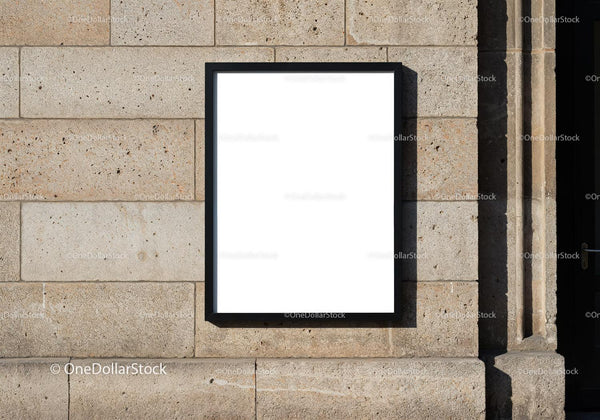 Blank poster frame on textured stone wall outdoors JPG Mockup Image