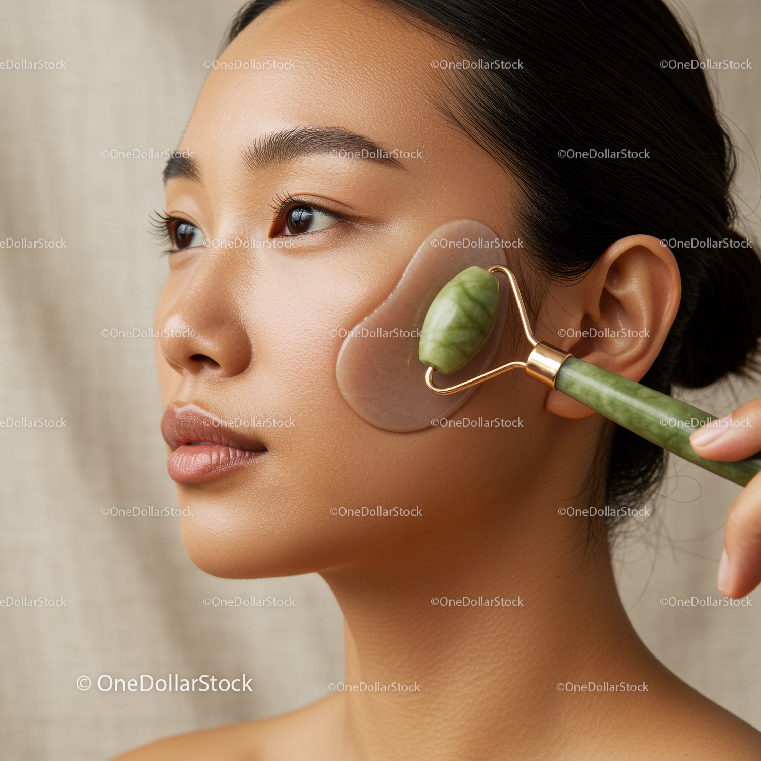 Asian Woman Using Jade Roller for Facial Skincare and Rejuvenation
