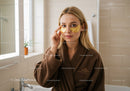 Young Woman Applying Eye Patches in Spa Relaxation Setting