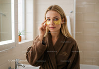 Young Woman Applying Eye Patches in Spa Relaxation Setting