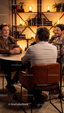 Three men engaged in a relaxed podcast discussion