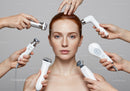 Woman with Freckled Skin Surrounded by Skincare Devices for Facial Treatment