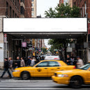 Busy urban street with yellow taxis and pedestrians
