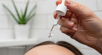 Close-up of Person Applying Eye Drops with Dropper for Skincare or Medical Treatment