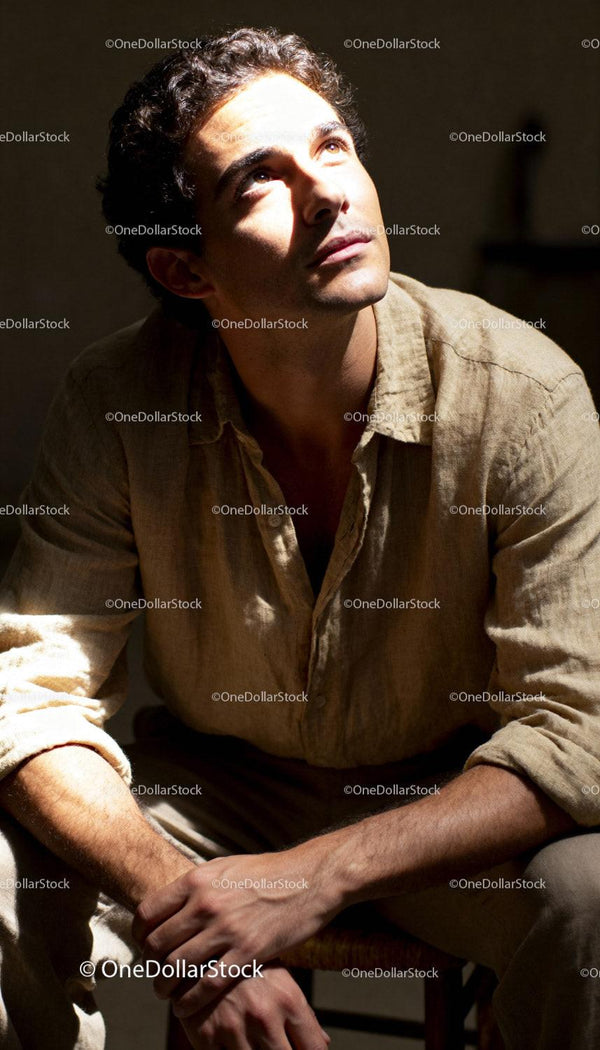 Young man lost in thought under warm sunlight