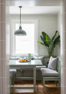 Bright and Cozy Indoor Dining Nook with Green Furniture and Houseplant