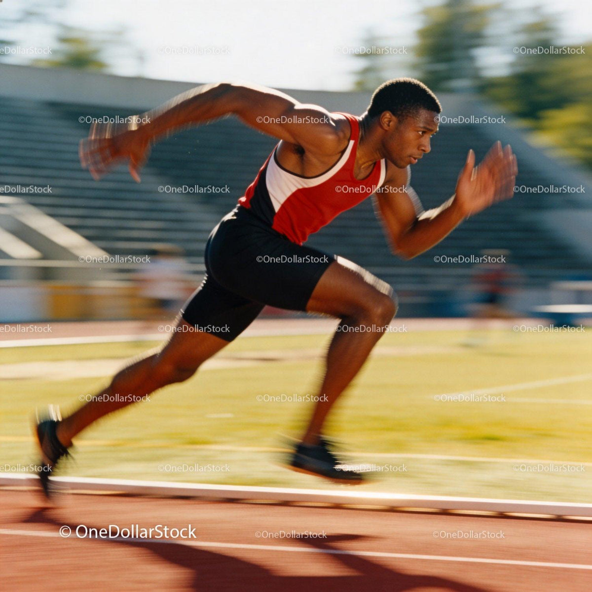 Sprinter powering forward on outdoor running track