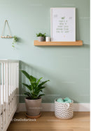 Stylish Baby Nursery with Green Walls and Indoor Plants