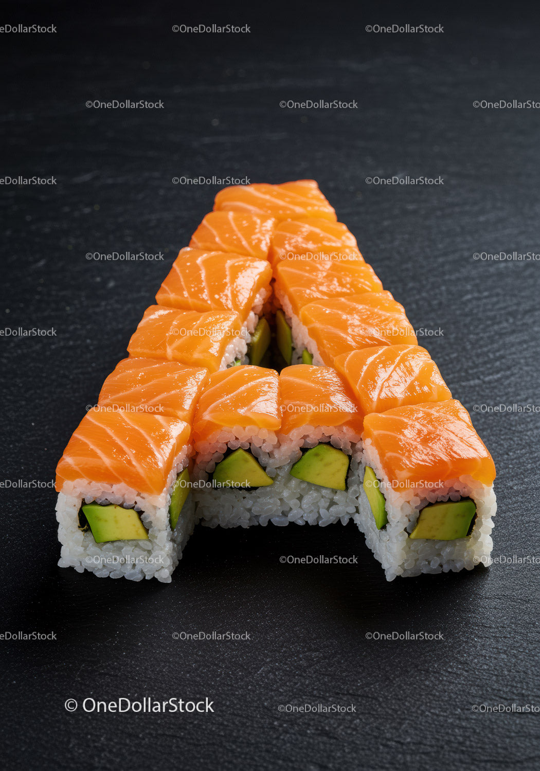 Sushi rolls shaped into letter A on dark slate