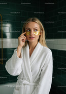 Young Woman Relaxing with Under-Eye Patches in Bathroom