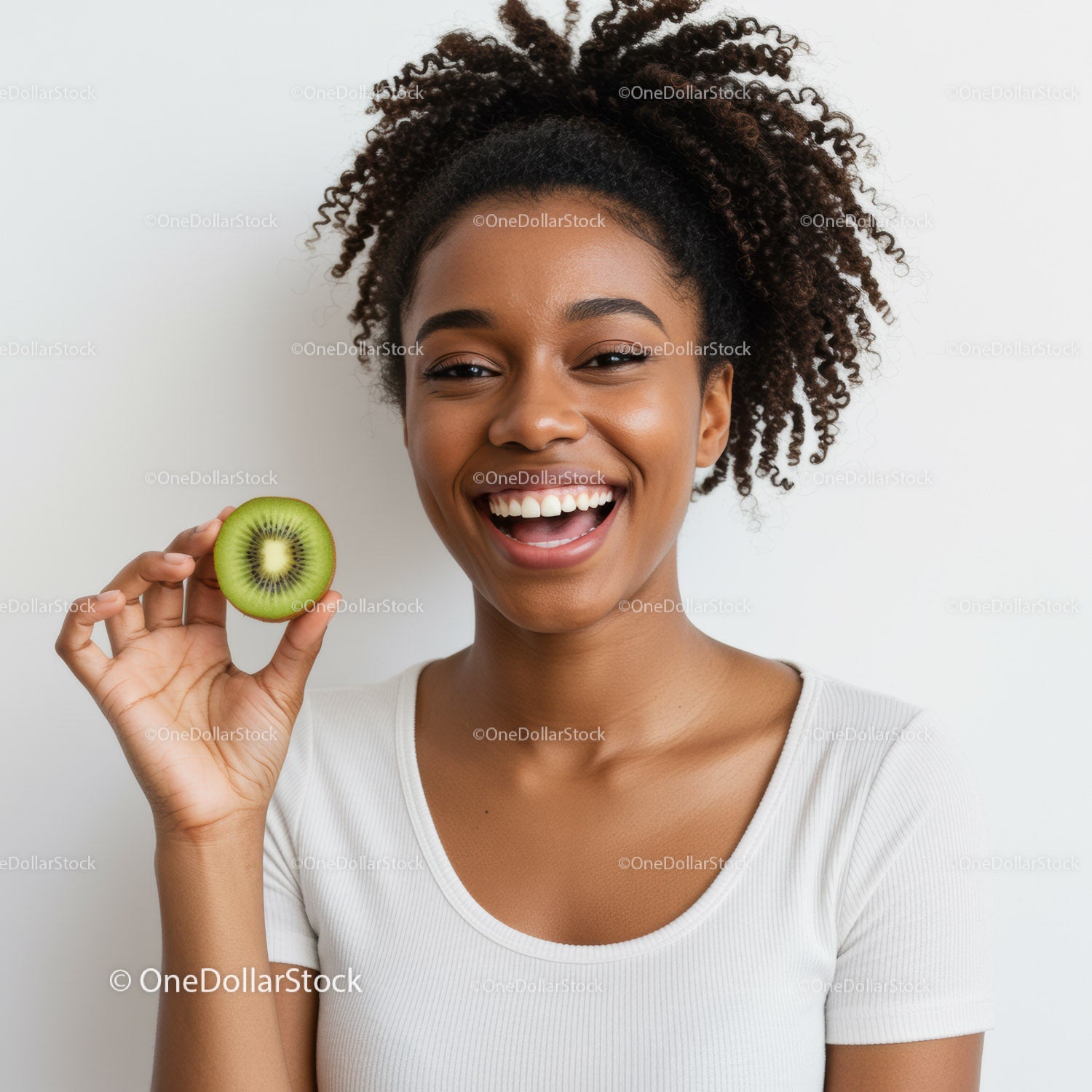 Joyful Woman Smiling While Holding a Kiwi Fruit for Healthy Lifestyle