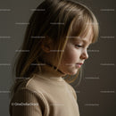 Thoughtful young girl in beige turtleneck sweater