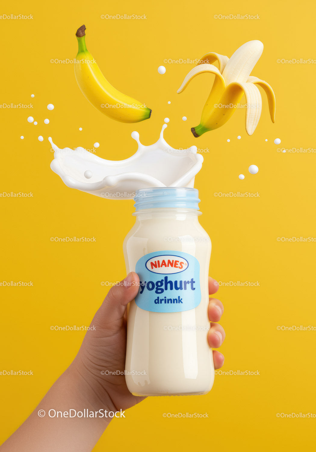 Hand Holding Banana Yogurt Drink with Splash on Yellow