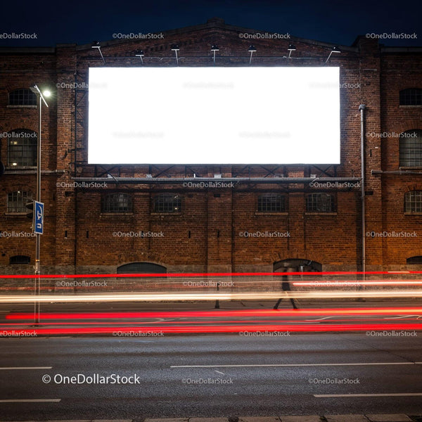 Empty illuminated billboard on old brick building at night JPG Mockup Image