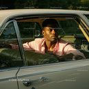 Young Man in Pink Shirt Sitting in Vintage Car on a Sunny Day