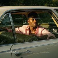 Young Man in Pink Shirt Sitting in Vintage Car on a Sunny Day