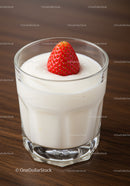 Fresh strawberry on creamy yogurt in clear glass