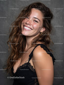 Portrait of a Smiling Woman with Wavy Brown Hair and Lace Top