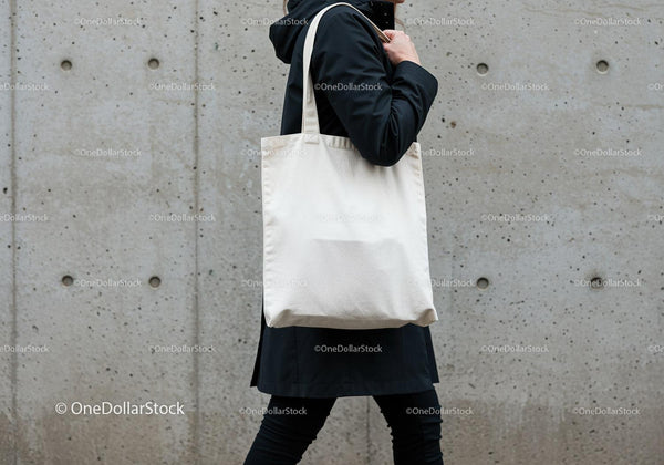 Person Carrying Plain Canvas Tote Bag Outdoors JPG Mockup Image