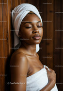 Relaxing Woman with Towel Wrap and Closed Eyes in Spa Environment