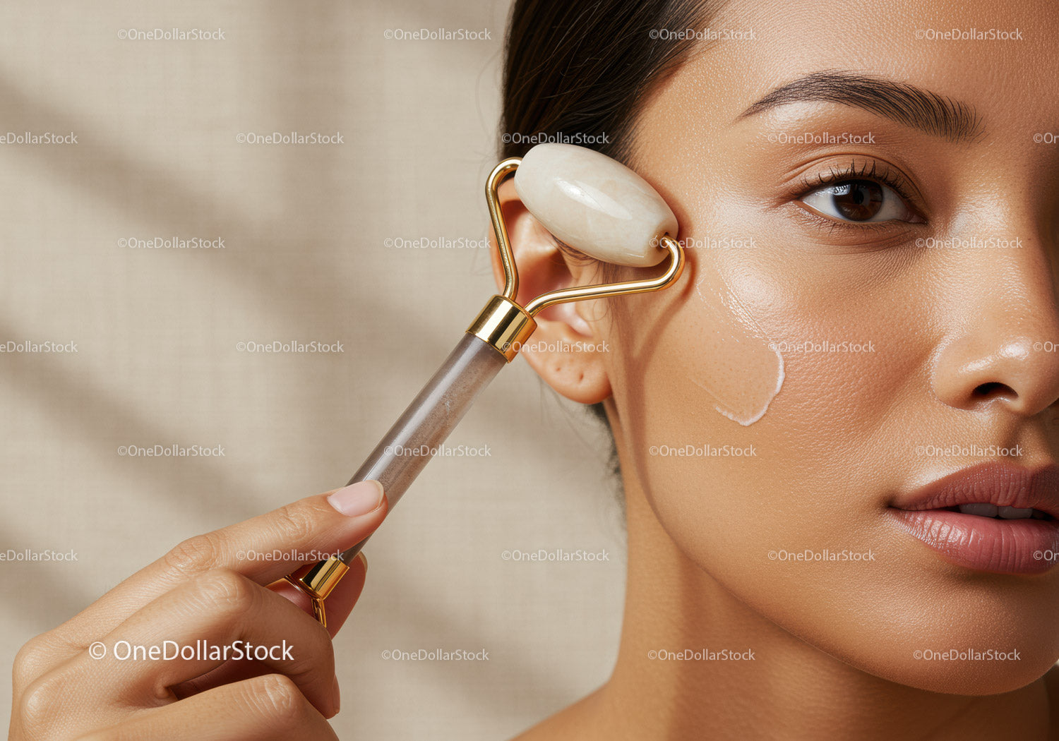 Young Woman Using Facial Roller for Skin Rejuvenation and Glow
