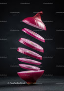 Floating sliced red onion against dark background