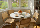 Cozy breakfast nook with natural light and fresh oranges