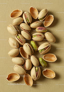 Close-up of scattered pistachio nuts with shells open