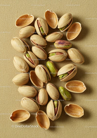 Close-up of scattered pistachio nuts with shells open