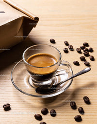 Freshly brewed espresso with coffee beans on wooden table