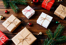 Holiday Gift Boxes with Pine Branches on Wooden Table