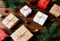 Holiday Gift Boxes with Pine Branches on Wooden Table