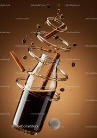 Glass bottle with iced coffee and cinnamon sticks floating
