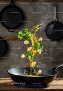 Fresh garlic and parsley splash in hot olive oil pan