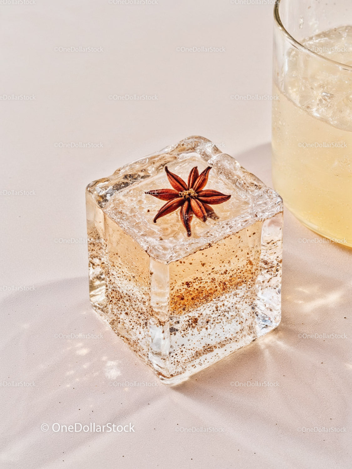 Ice cube with star anise spice and a cold drink