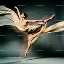 Graceful ballerina performing a high leap with flowing dress