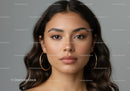 Beautiful Young Woman with Wavy Hair and Hoop Earrings