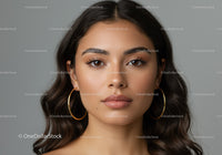Beautiful Young Woman with Wavy Hair and Hoop Earrings