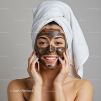 Young Woman Applying Black Face Mask with Towel on Head