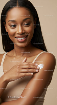 Portrait of a Smiling Woman Applying Lotion to Her Arm for Healthy Skin