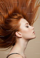 Profile of Woman with Flowing Red Hair in Soft Light