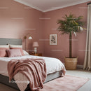 Stylish Bedroom with Pink Walls and Large Indoor Palm Plant