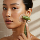 Elegant Woman Using Jade Roller for Skincare Routine