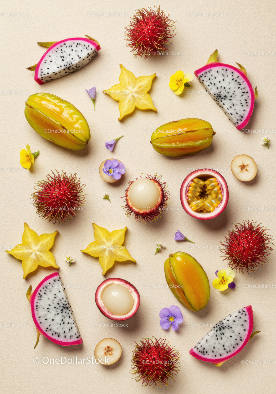 Exotic fruits arranged with delicate flowers on beige background