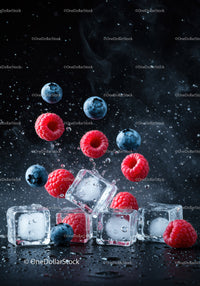 Fresh raspberries and blueberries with ice cubes splash