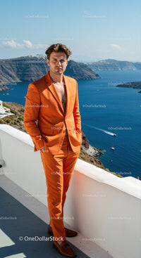 Man in orange suit standing by seaside terrace
