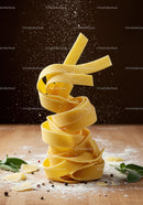 Sprinkling Flour Over Fresh Tagliatelle Pasta Nest