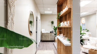 Modern Wellness Reception with Wooden Shelves and Greenery