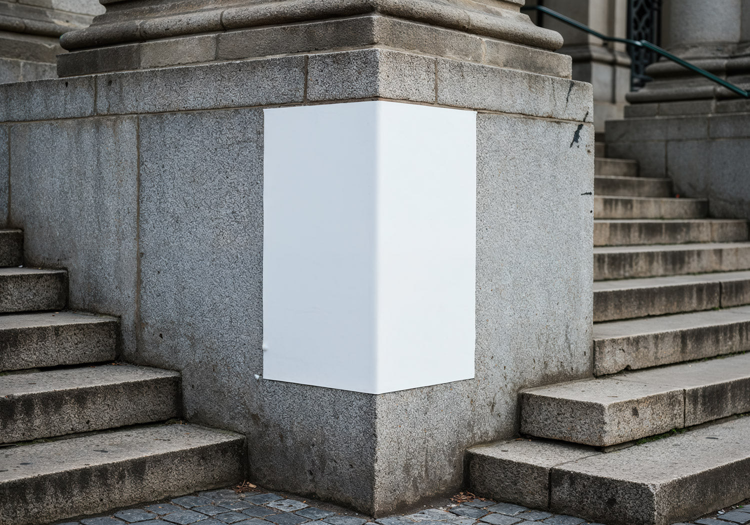 Blank white poster on urban stone stairway corner